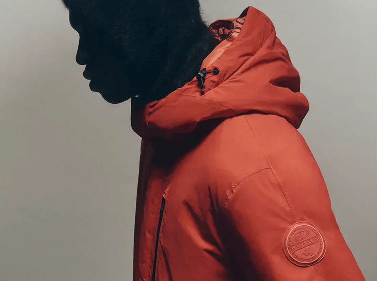 A person wearing Napapijri insulated jacket in orange