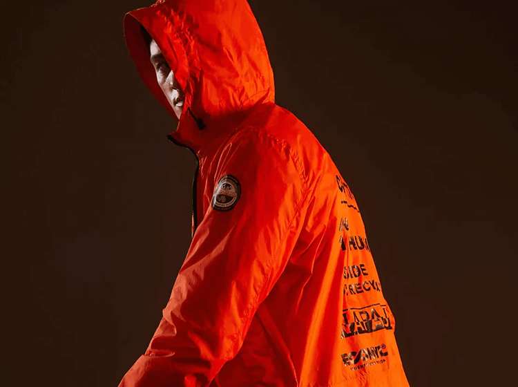 A person wearing Napapijri hooded jacket in red, close-up showing hood construction