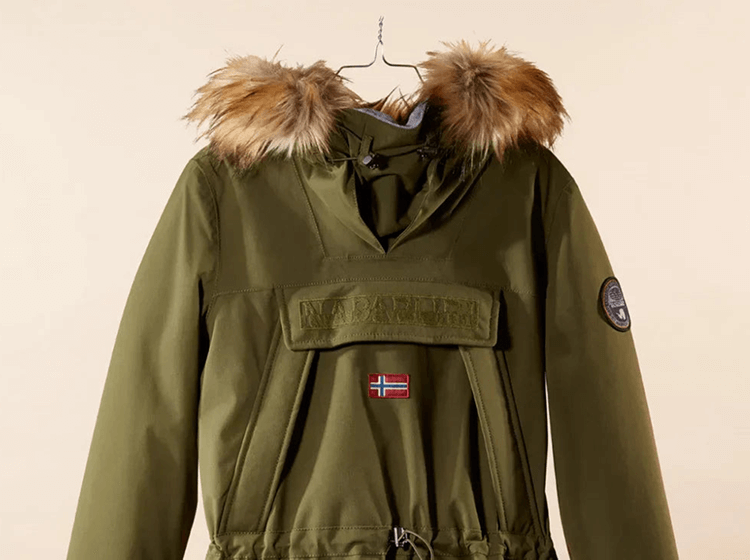 Close-up of an olive green anorak jacket with fur-trimmed hood.