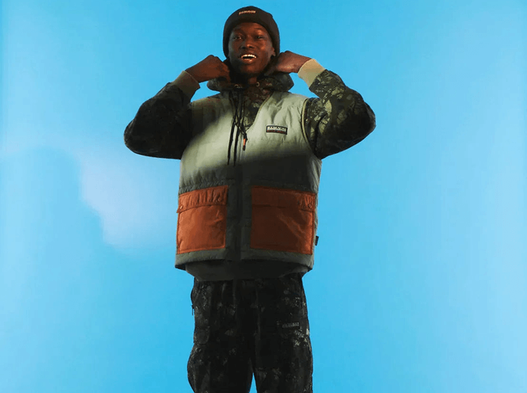 A person wearing Napapijri padded vest and hoodie showing layered outerwear styling