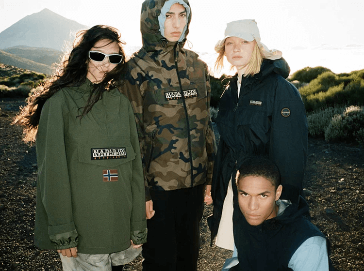 A group of people wearing Napapijri outdoor jackets in mountainous natural landscape.