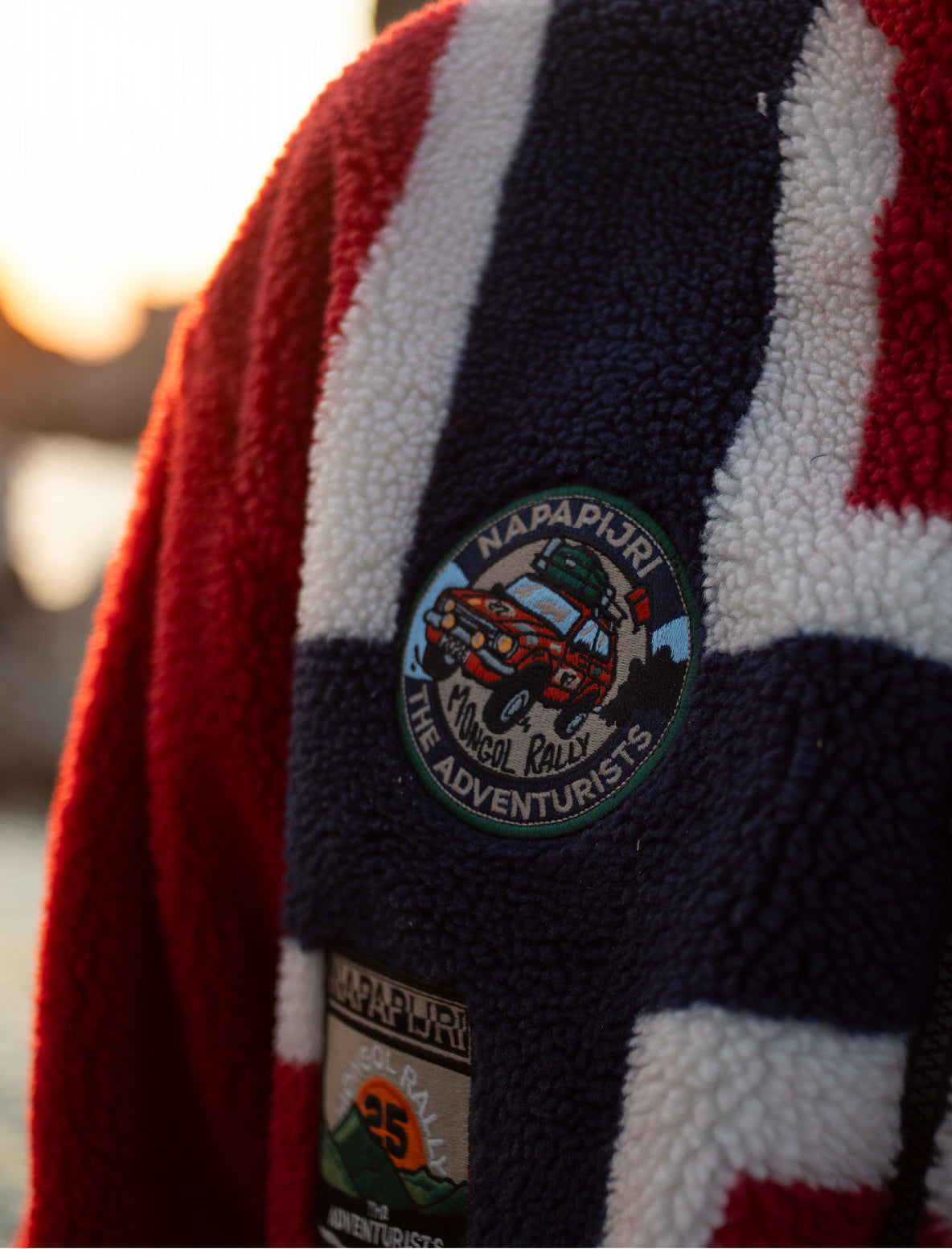 A Napapijri textured fleece garment with red, white, and navy stripes.