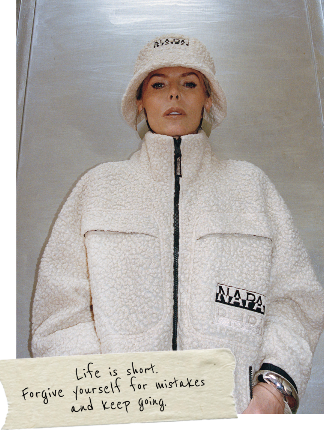 A person wearing white Napapijri fleece jacket with zip front and chest logo detail
