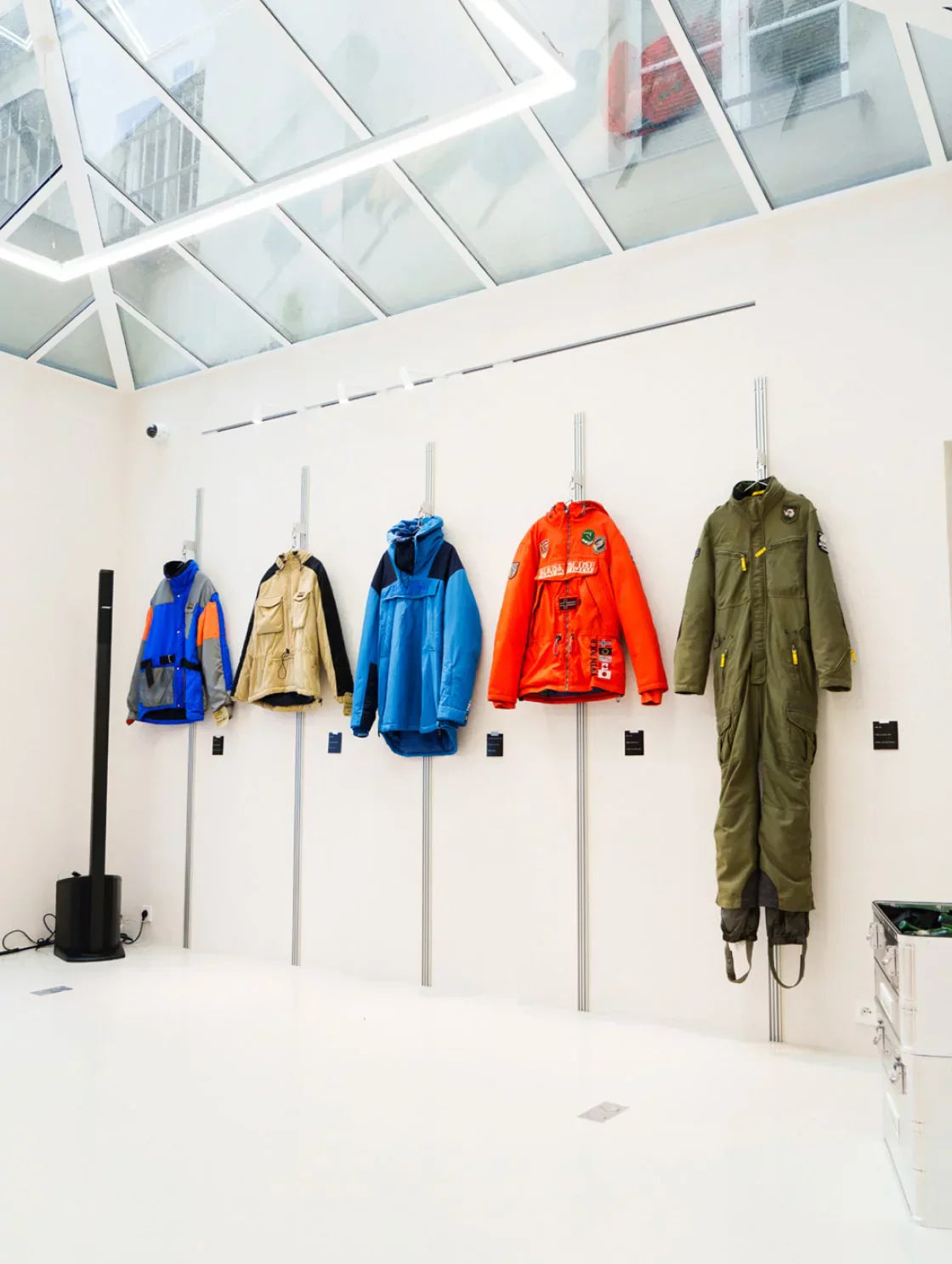 Napapijri jackets and outerwear displayed on wall inside showroom space.