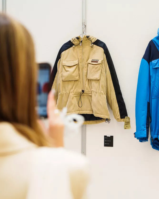 Beige Napapijri field jacket displayed on a wall.
